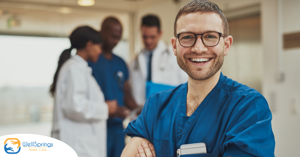 A young man in healthcare smiles, representing how a career as a professional caregiver can lead to a happy career as a healthcare professional.